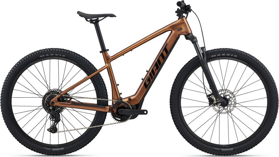 MTB „Giant Fathom E+ 29 2“ (Kopie) in Bronze/Schwarz mit breiten Reifen und „GIANT“-Schriftzug auf dem Rahmen.